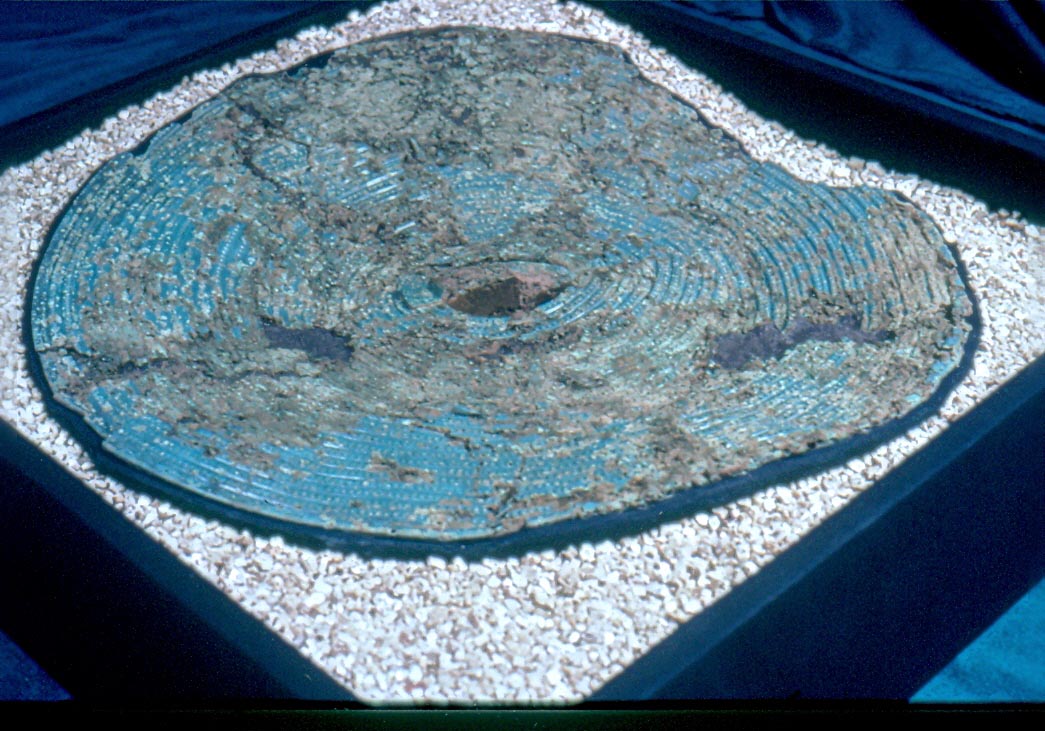 A large round shield laying in a square box A large round shield laying in a square box