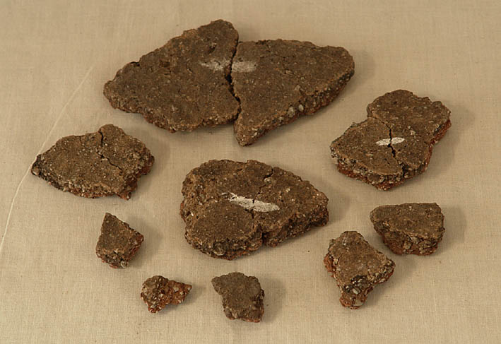 Nine fragments of pot on a pale background Nine fragments of pot on a pale background