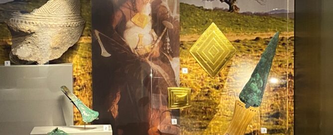 Museum display case with gold items and other archaeological finds