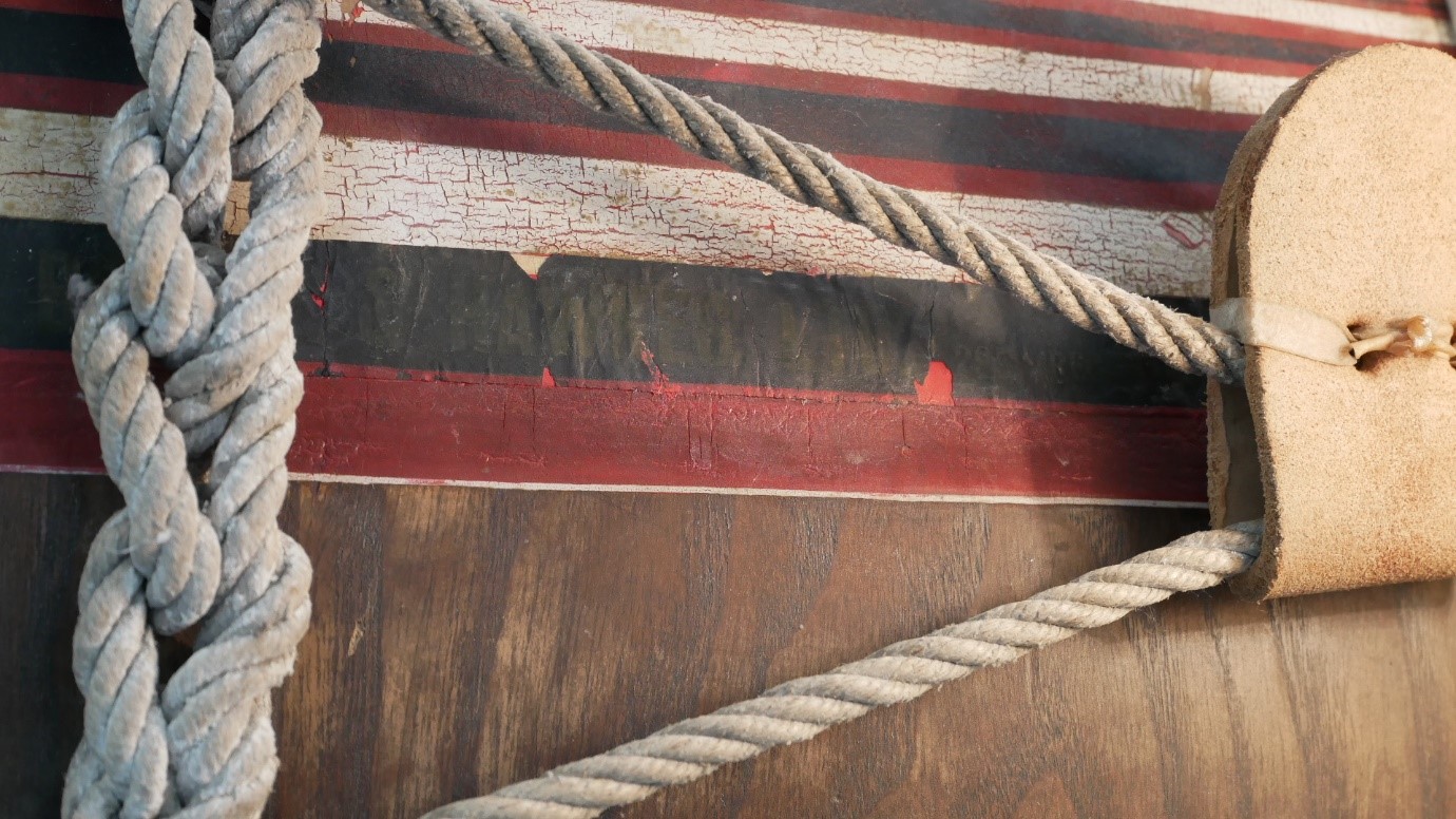 Close-up view of the side of the drum showing red, black and white paint layers re-bonded to the surface