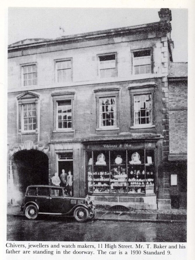 Black and white image of terraced frontage with windows of domestic flats above and shop front below reading 'Chivers & Sons'
