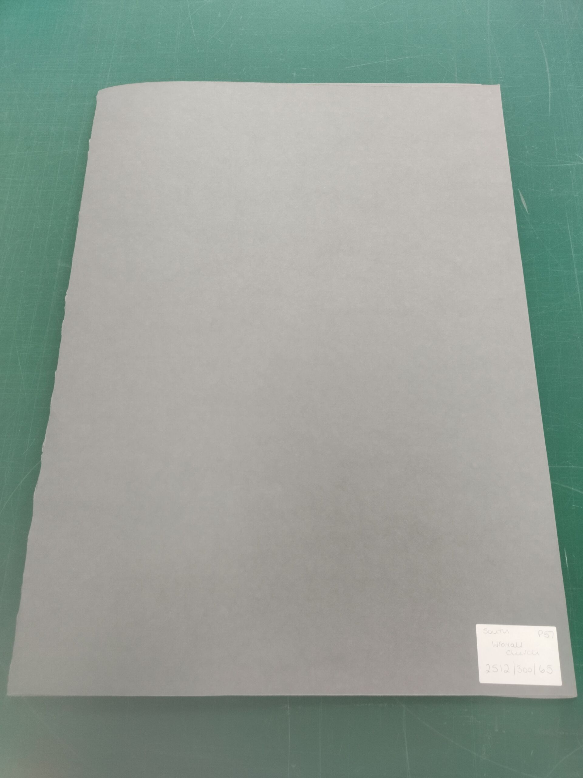 Overhead view of large blue folder with label in bottom right corner