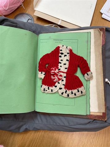 Small red jacket bordered in white with black spots.
