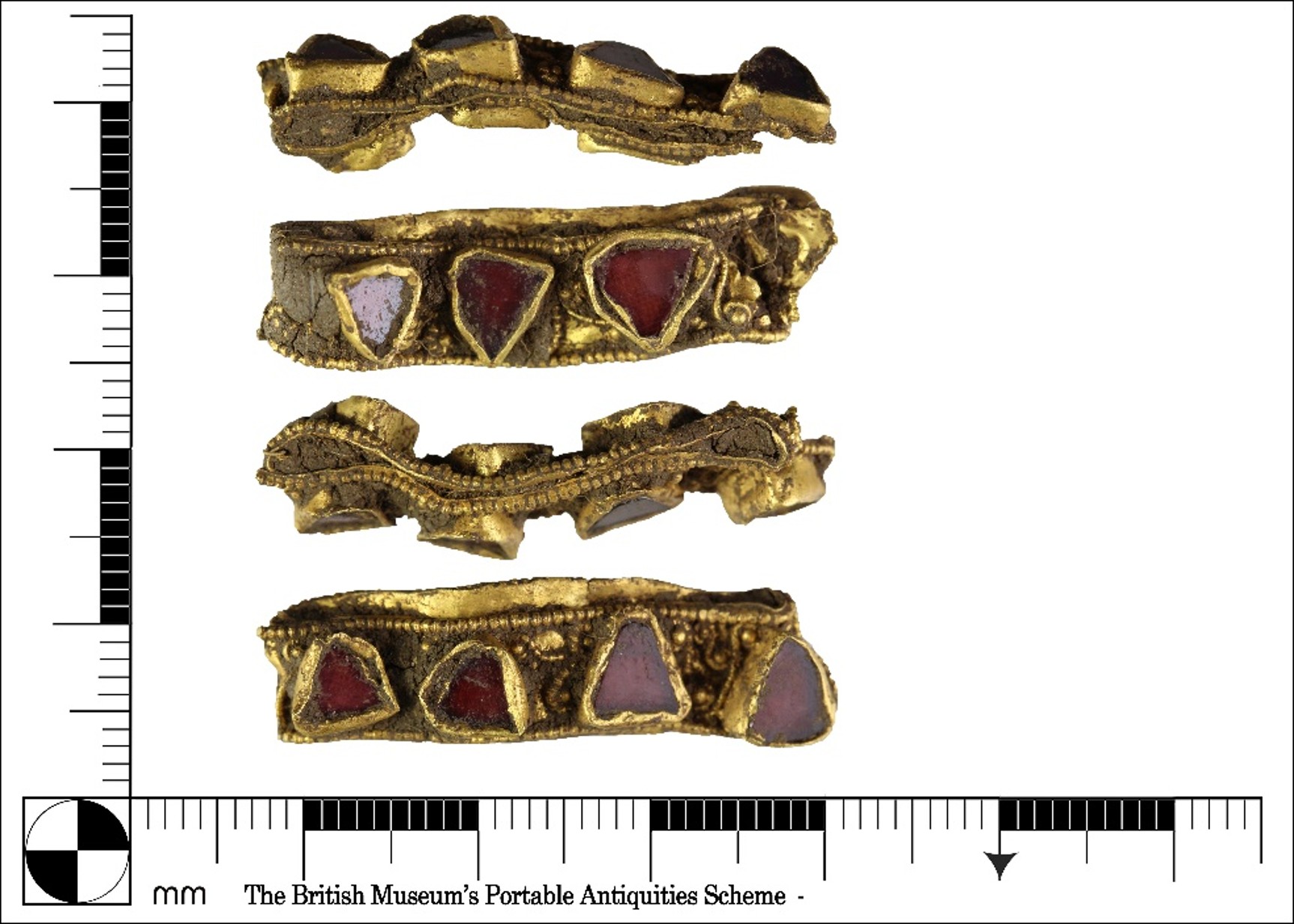 Scale image showing four views of ornate gold ring with irregular triangular red gems inserted.